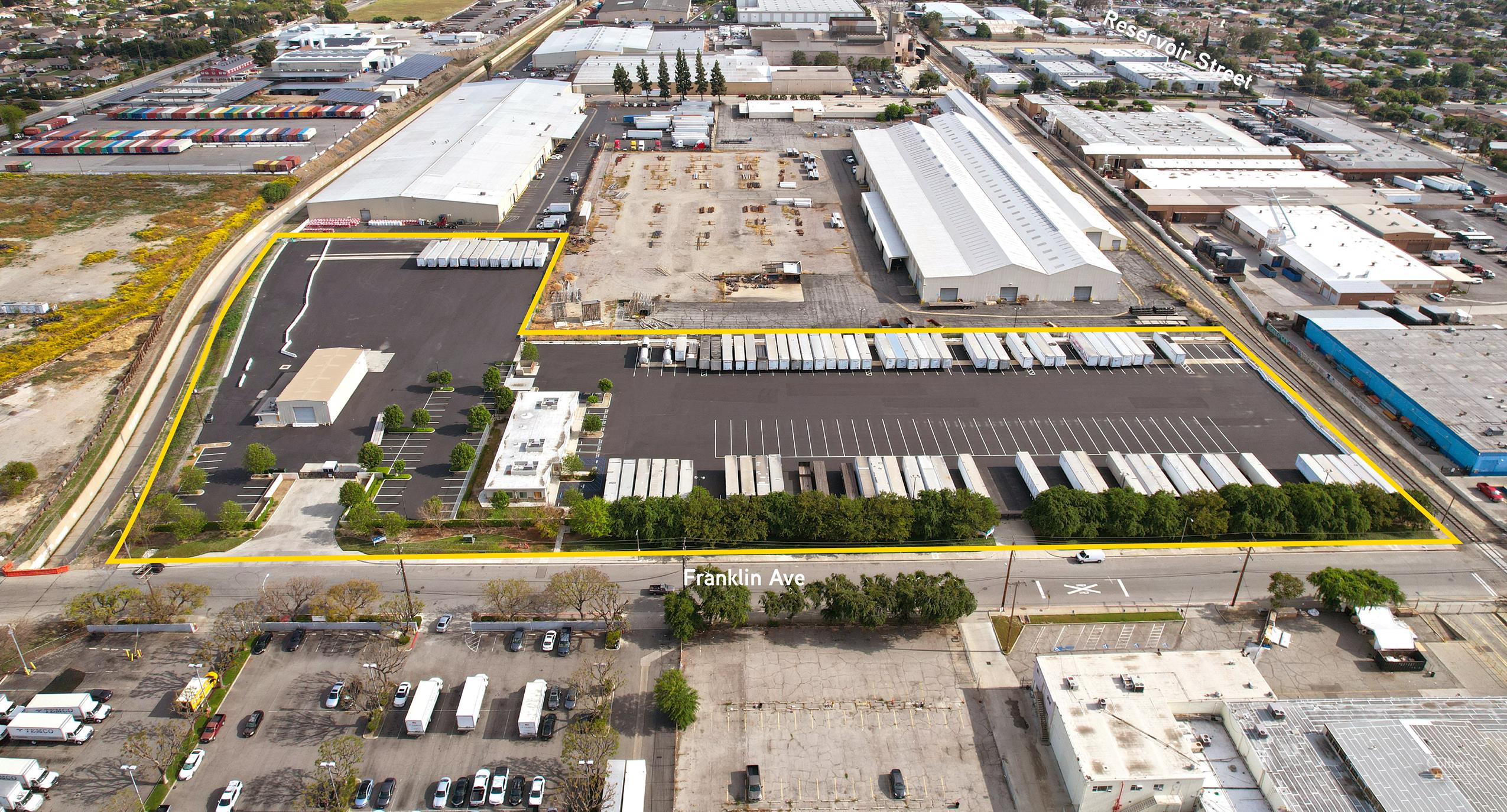 Industrial outdoor storage yard with trailers and industrial buildings